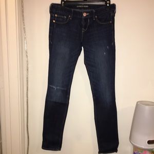Lightly distressed dark wash ankle skinny jeans