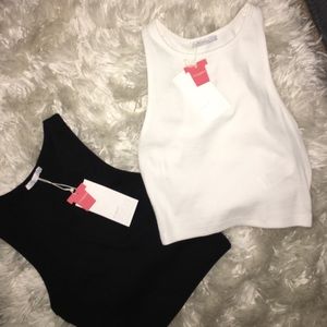 White and black cropped top tanks.