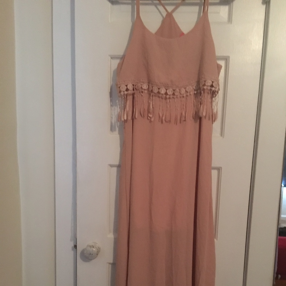 Peach maxis dress with tassels.