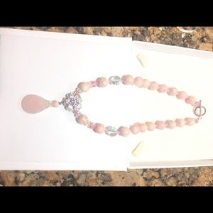 Necklace of pink stones and crystals.