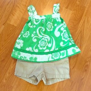 Green and white floral top with khaki shorts