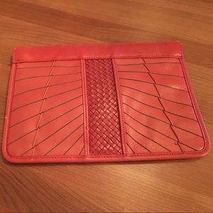 Bright orange leather clutch