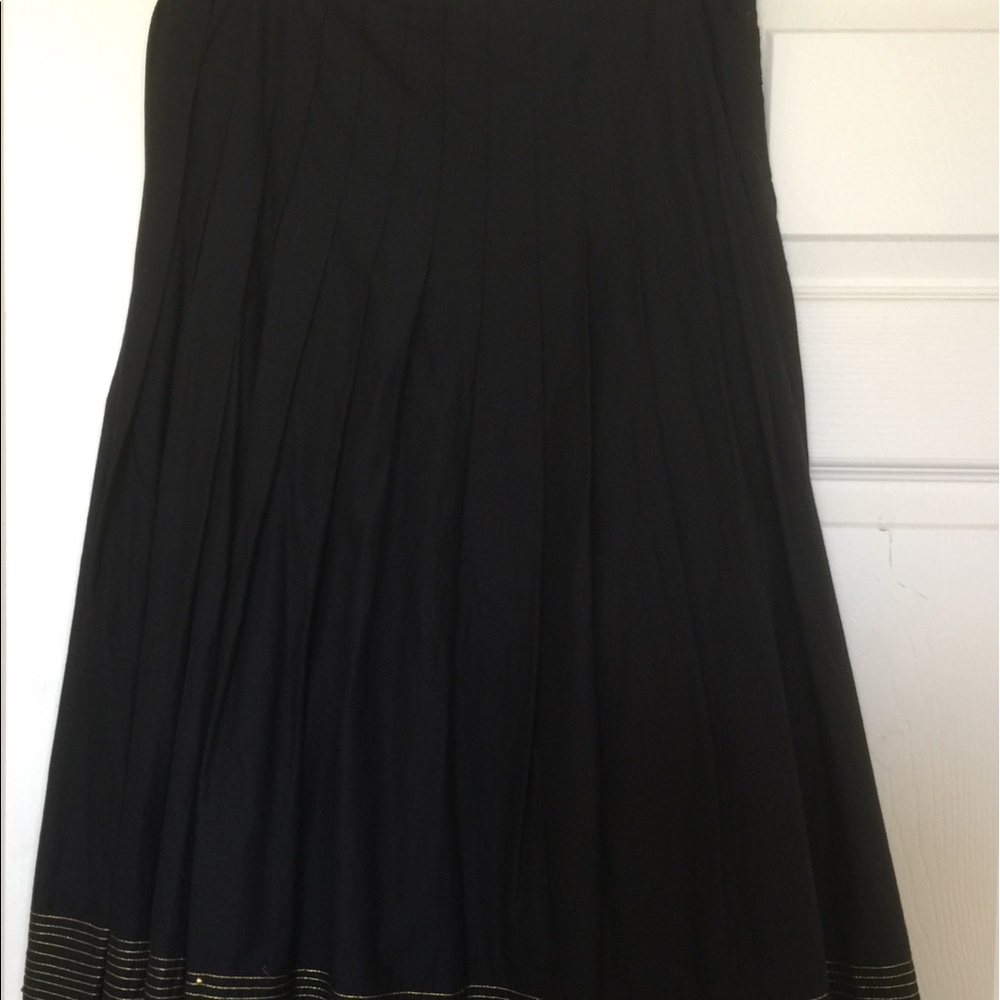 Pleated skirt with gold trim close to hem