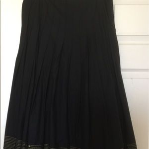 Pleated skirt with gold trim close to hem