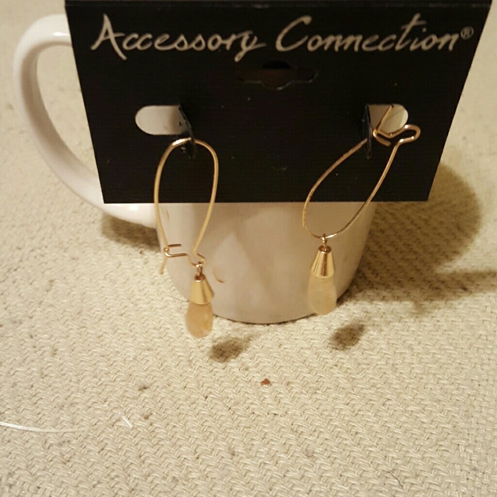 Long earrings with a pale pink stone hanging from