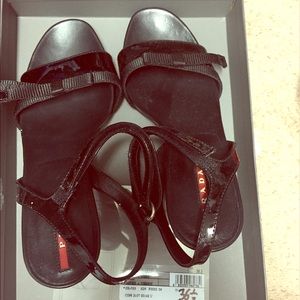 Black patent wedge Prada sandals with bow