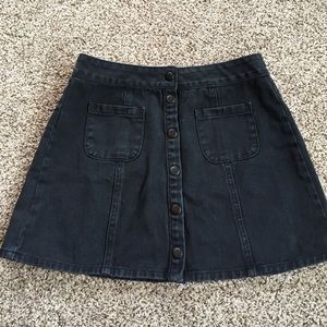 Snap up black denim skirt.