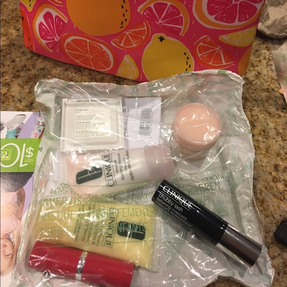 Brand new Clinique travel size make up w/ bag