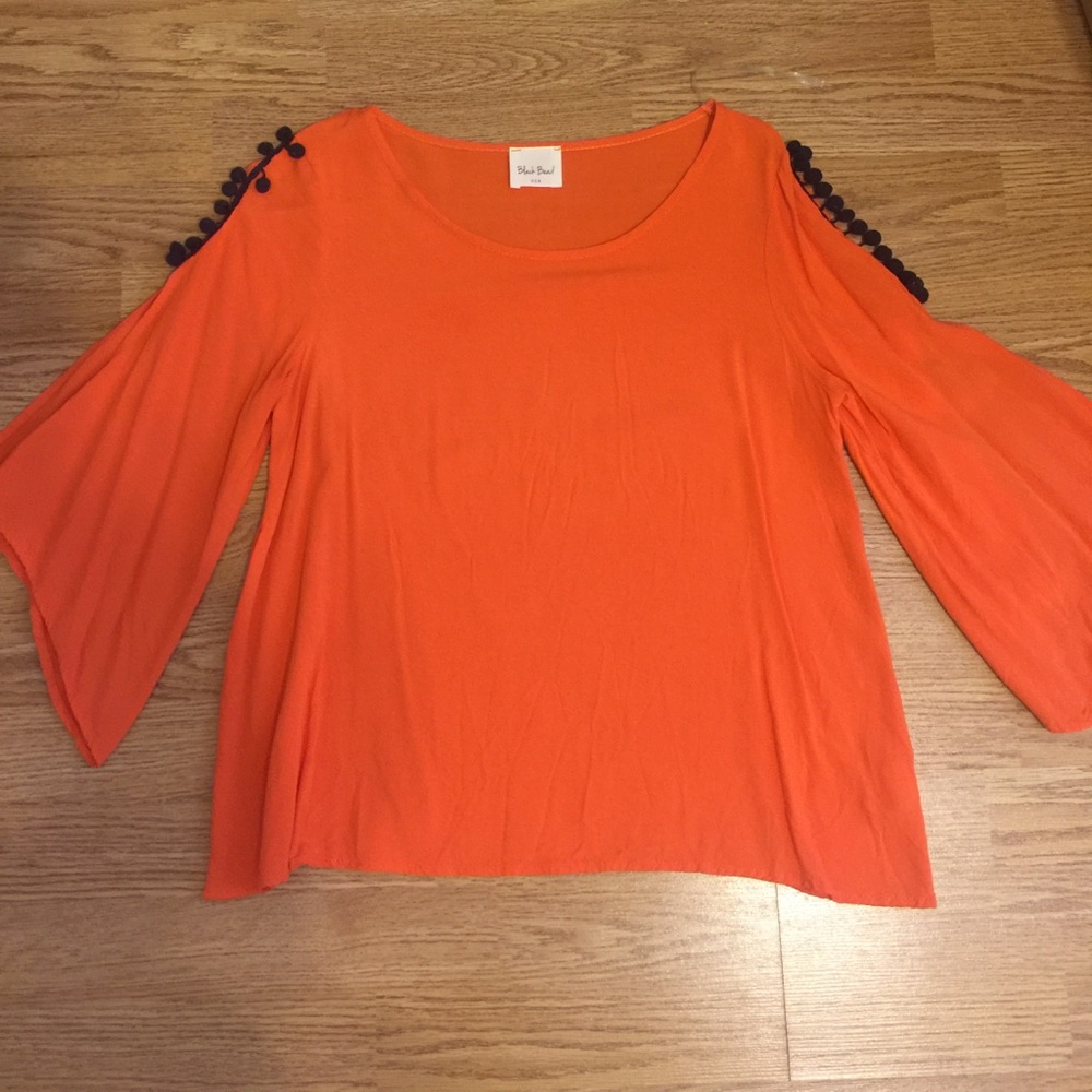 Orange boutique shirt with navy blue pompoms