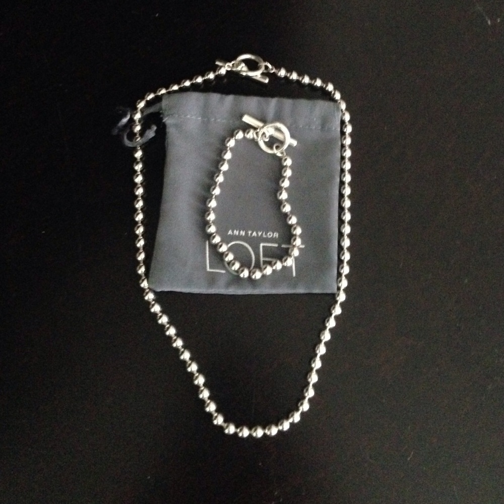 Silver colored necklace and bracelet set
