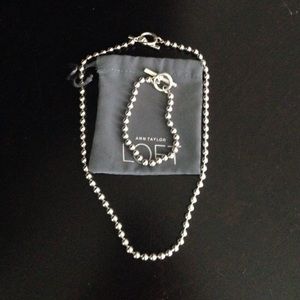 Silver colored necklace and bracelet set