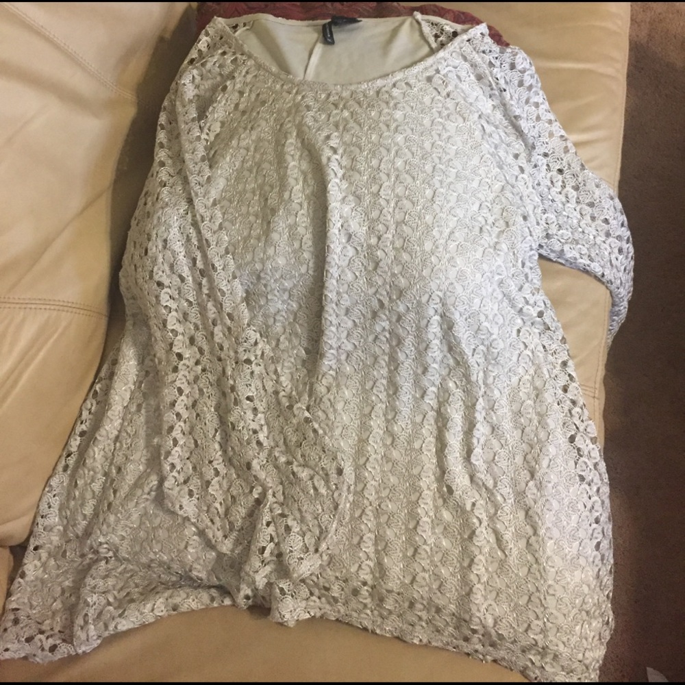 Cream colored loose fitting top with lining.