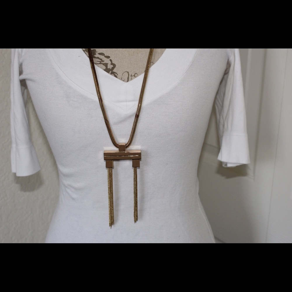 Long gold necklace with funky pendant