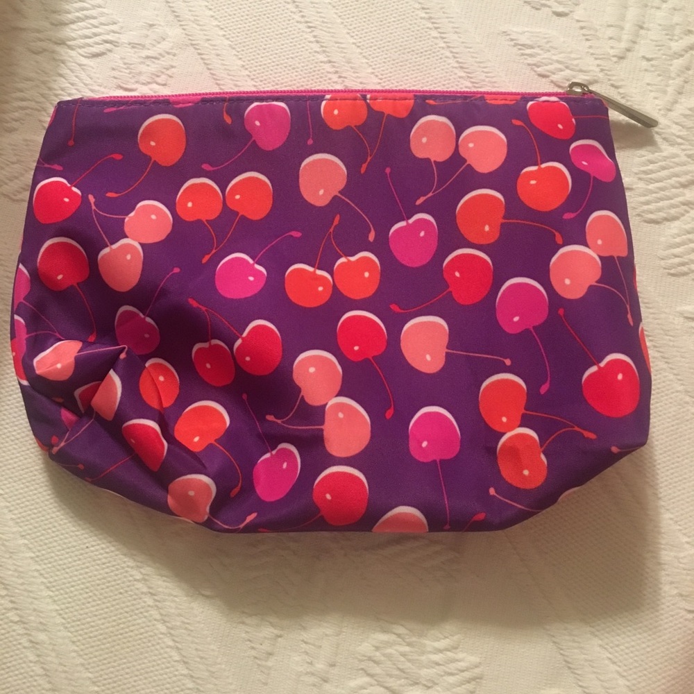 A multi colored cherry Clinique makeup bag