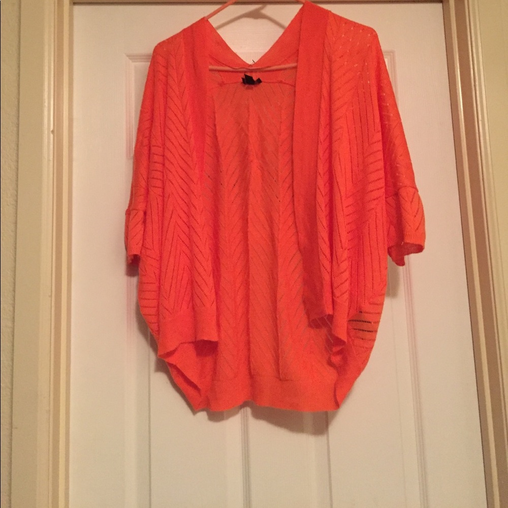Light orange cardigan.