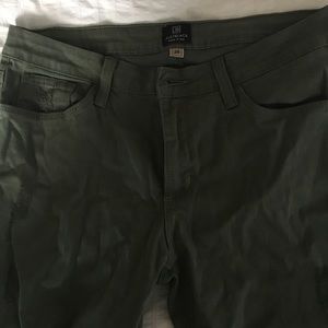 Green jeans with rip in right knee