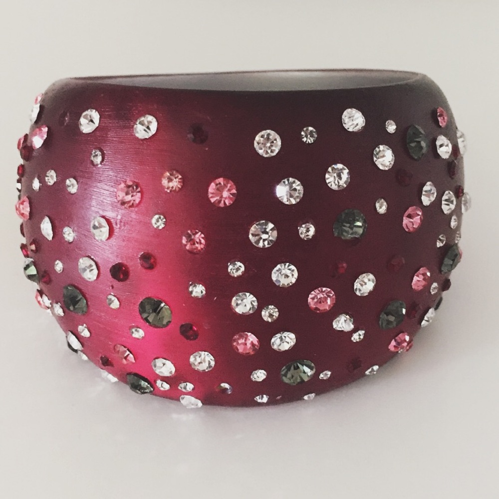 Red resin bangle with crystals.