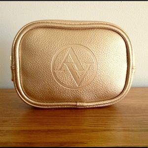 Adrienne Vittadini gold leather makeup bag