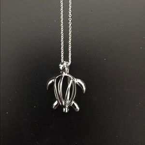 Silver turtle cage necklace with pearl