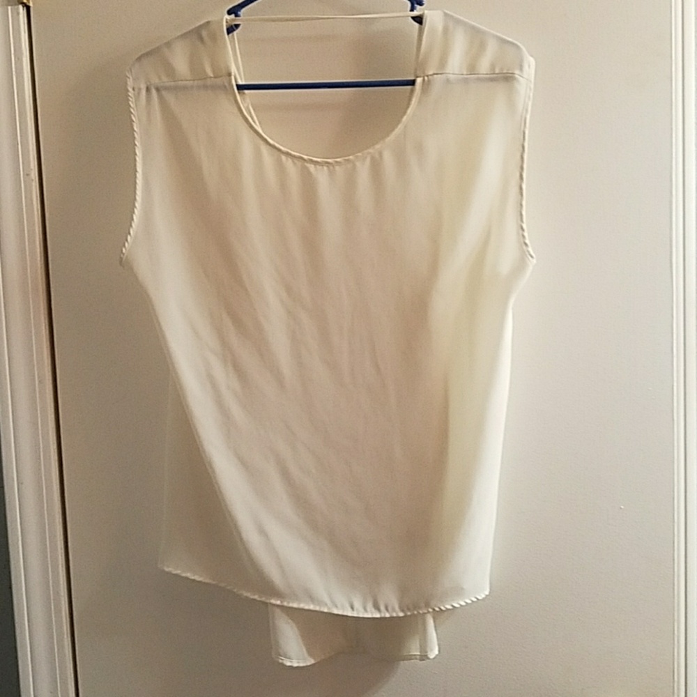 Cream colored flowy kind of see-through shirt.