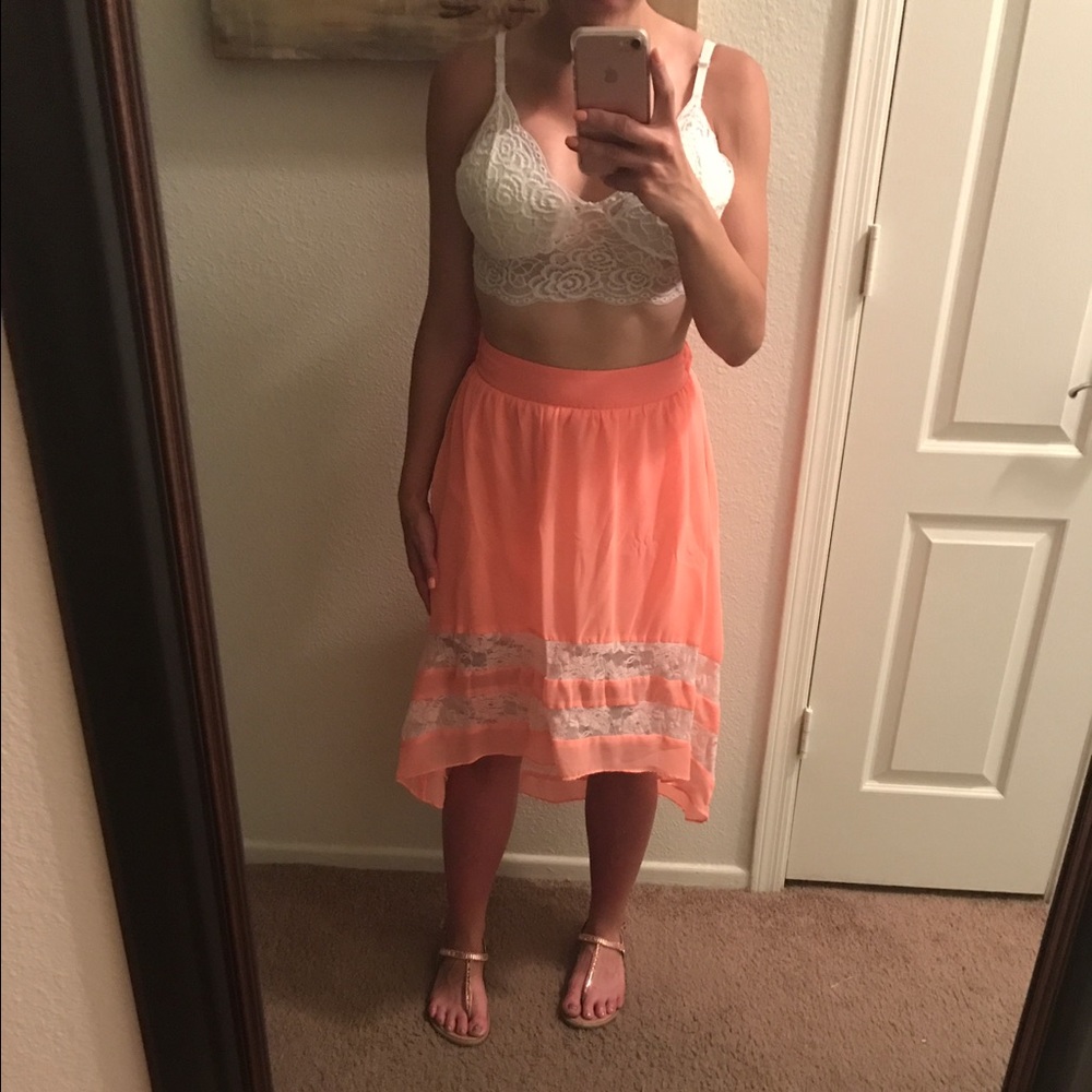 Bright coral high low skirt with lace accents