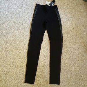 Black leggings with leather accent.
