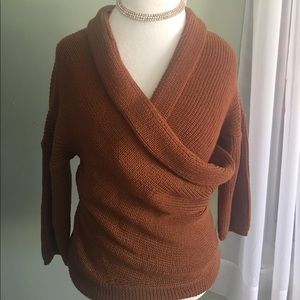 Rust scoop neck sweater.