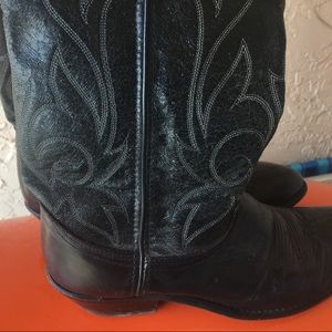 Black leather embroidered cowboy boots.