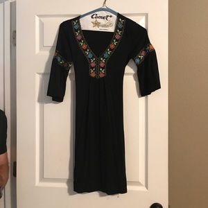 Super cute black dress. V-neck & tie in the back.
