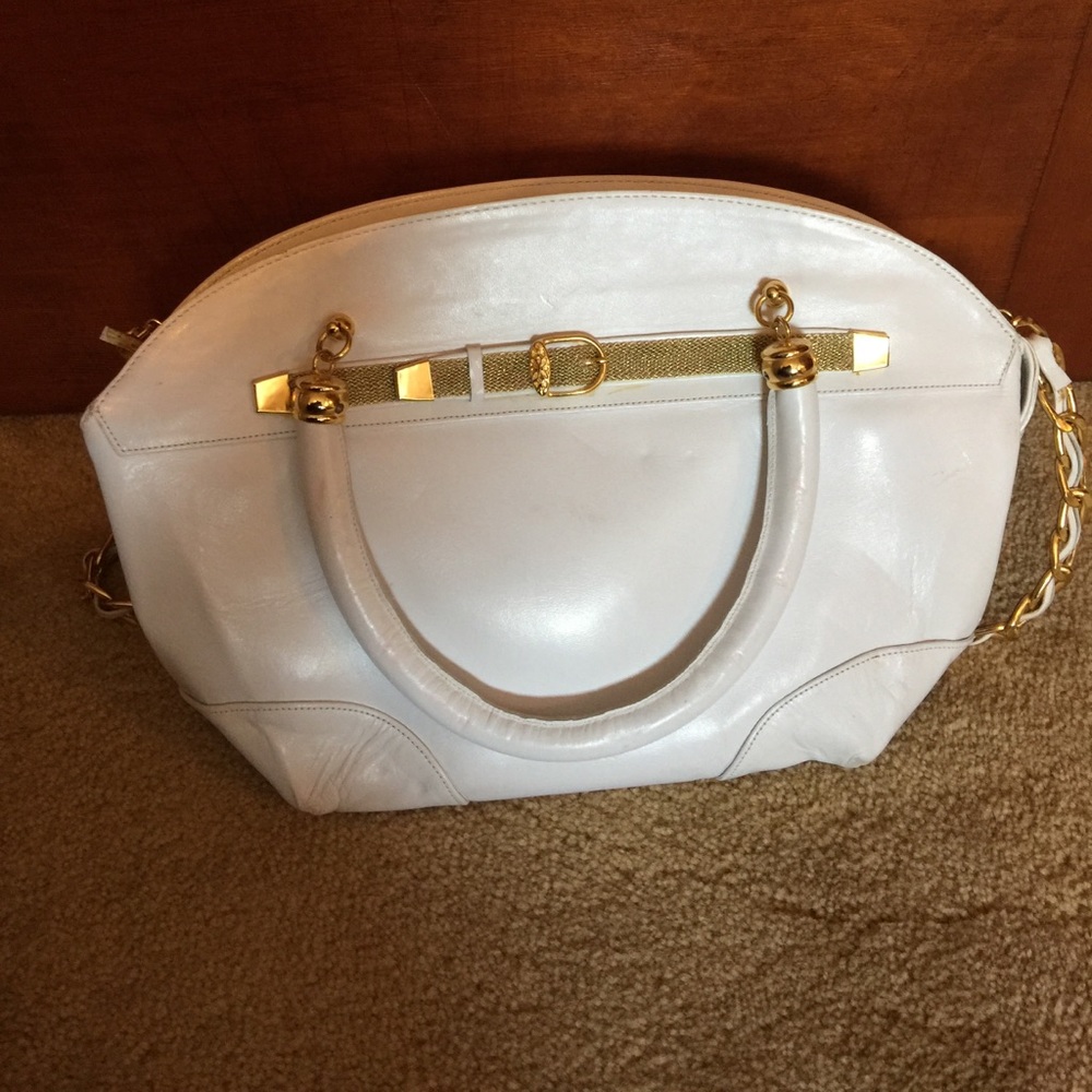 Leather white purse with gold details.