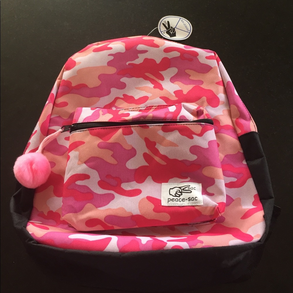 Pink camo backpack with pink puff ball charm