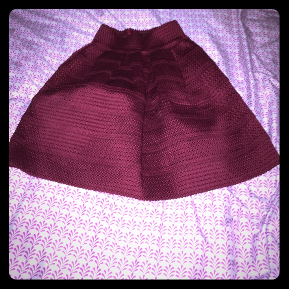 Maroon 85% polyester 15% spandex skirt.