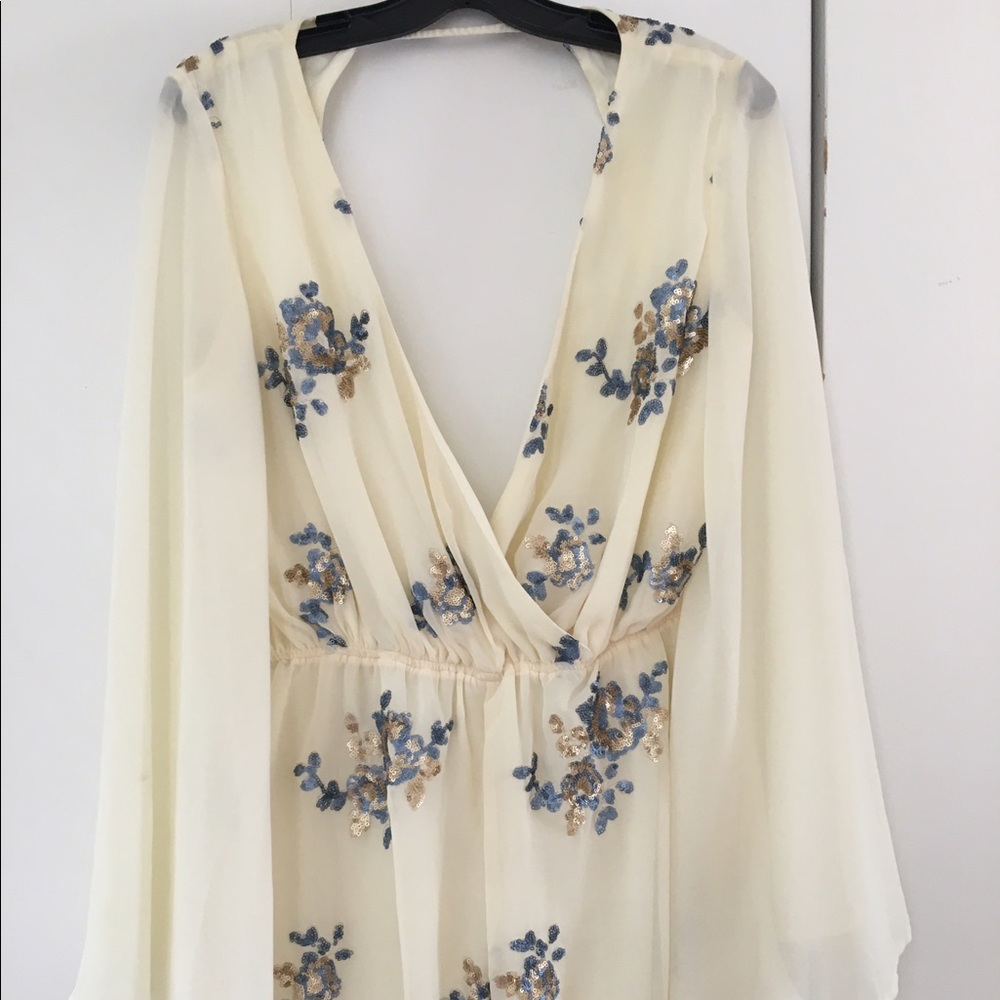 Cream cut out romper with sequin floral accents