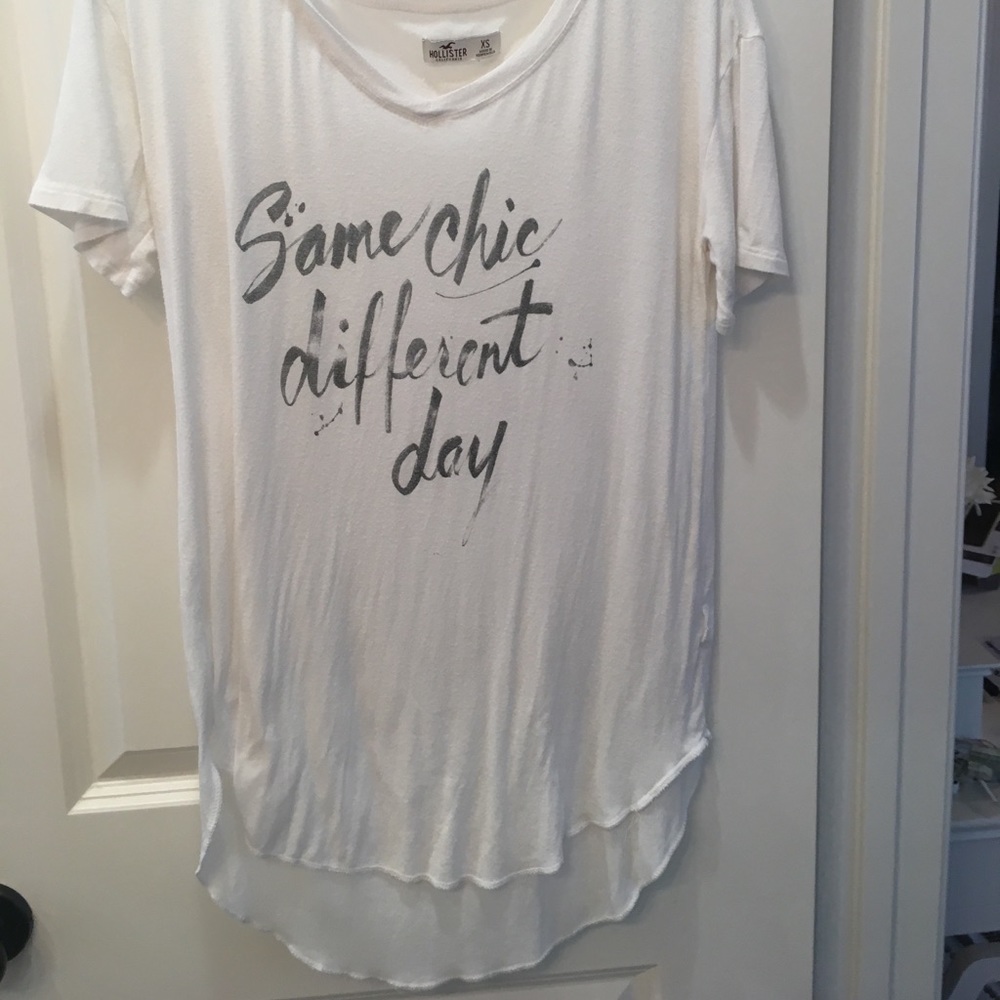 This is a white, v-neck t-shirt with black writing