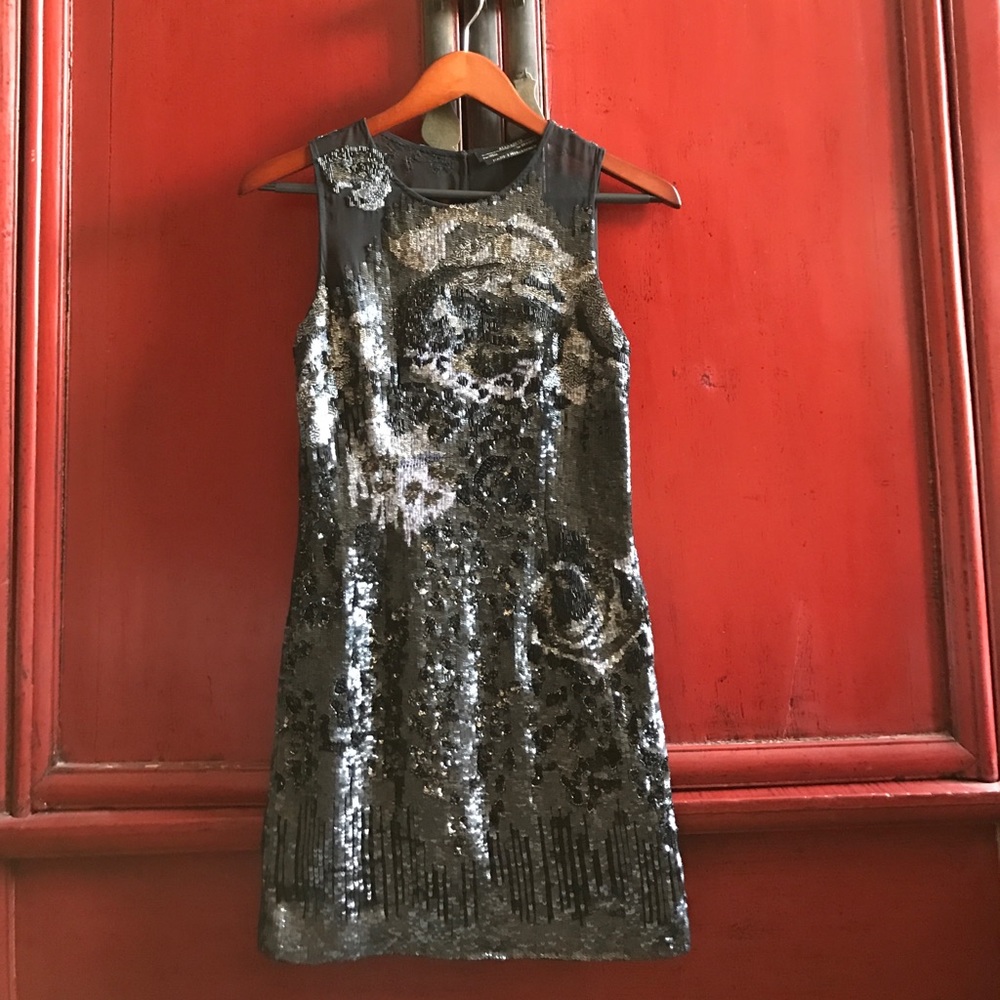 Exquisitely embellished short black dress.