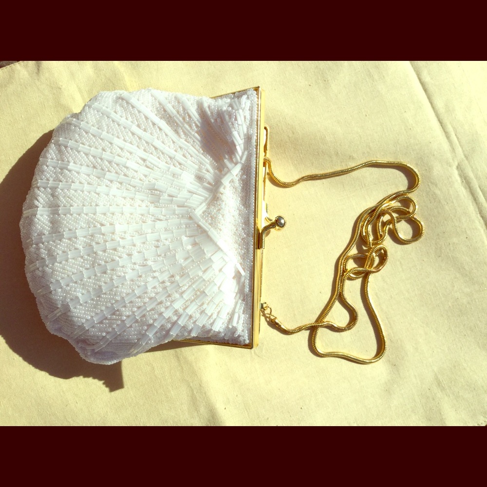 Elegant white bead purse with gold strap.