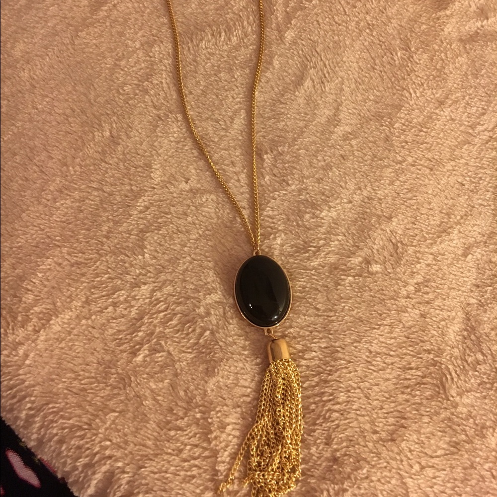 Gold necklace with black medallion gold tassel