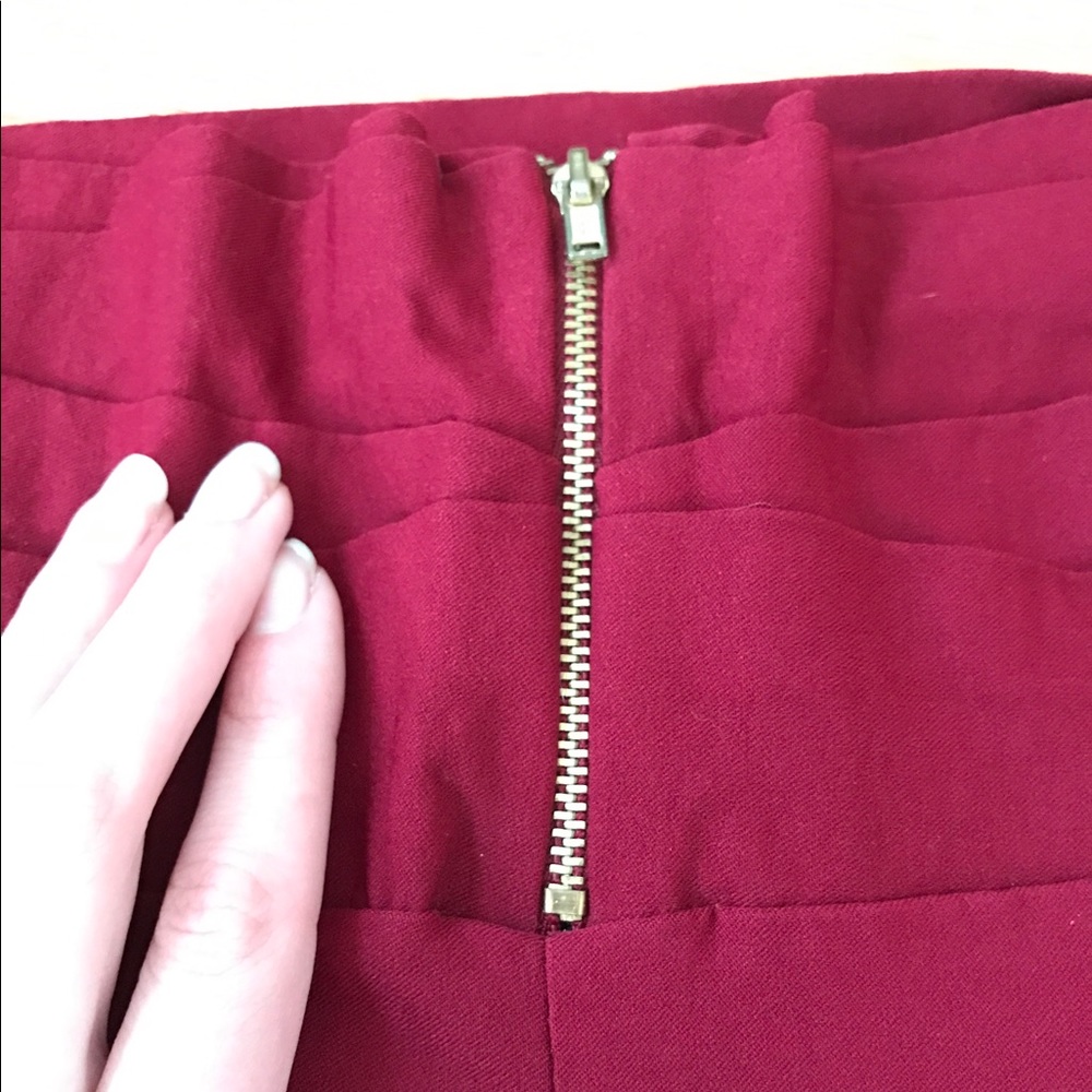 Red leggings with a gold zipper