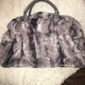 A faux fur carry on bag