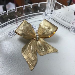 Gorgeous gold color brooch with stones in center