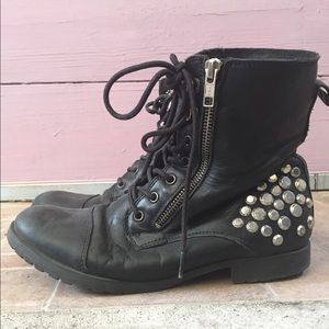 Black combat boots with studs on the sides