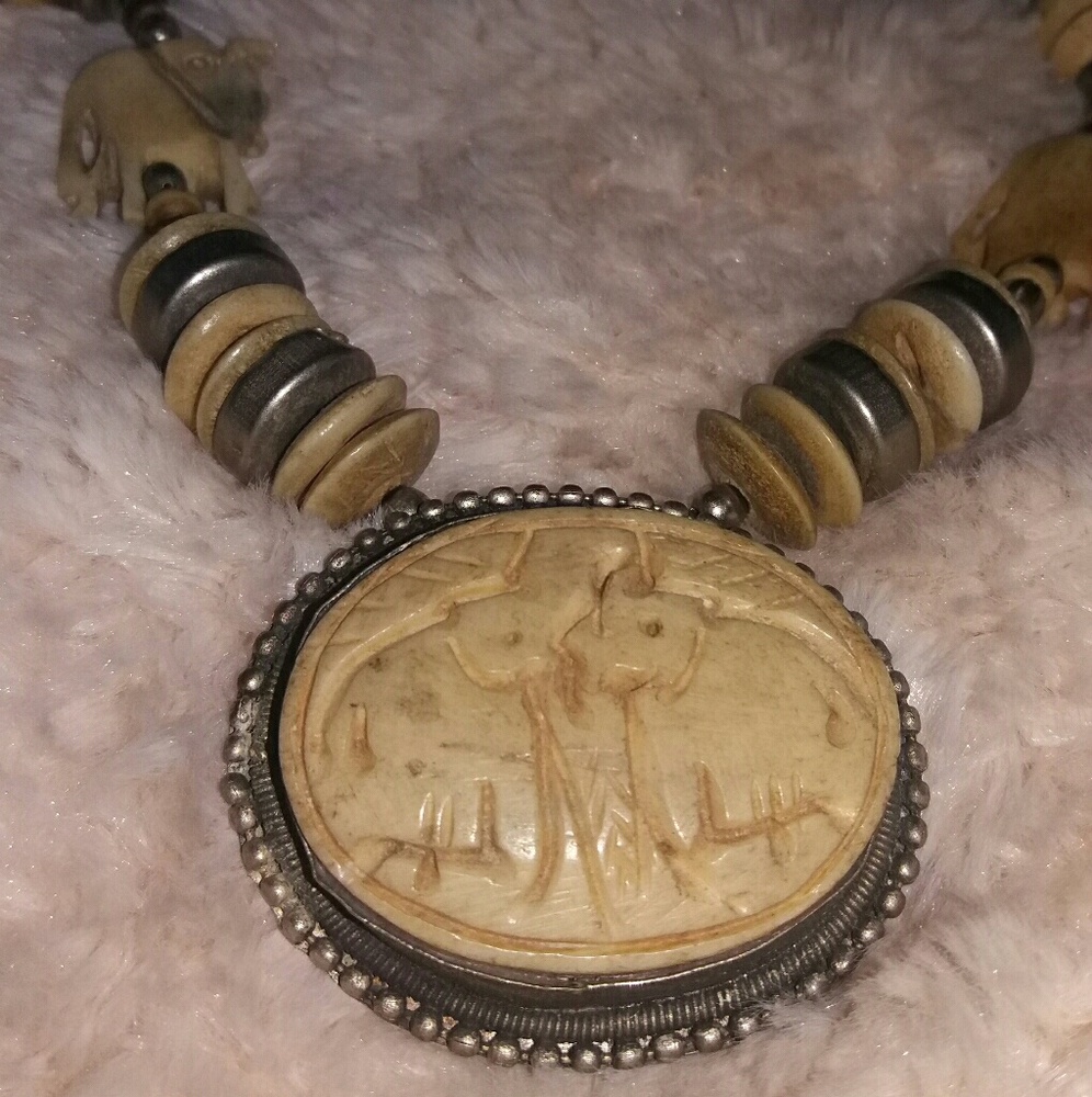 Faux ivory necklace with carved elephants