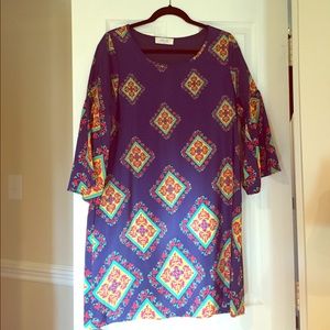 Navy dress with bell sleeves and medallion design.