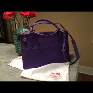 Purple Coach handbag. New with tag and dust bag.