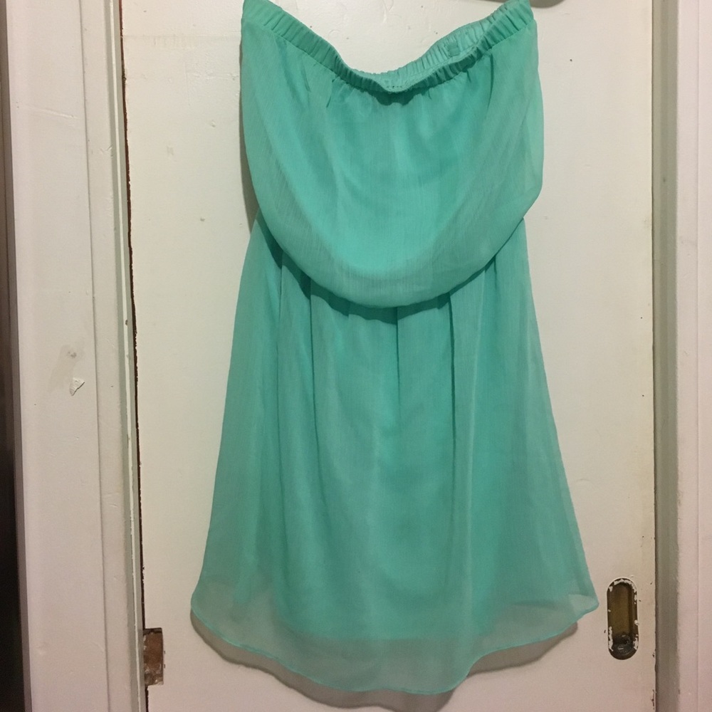 Mid-length strapless/sleeveless dress.