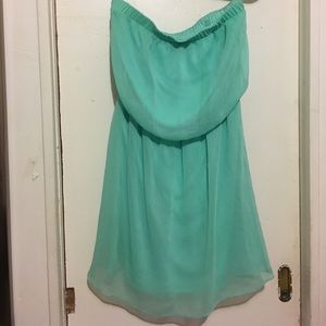 Mid-length strapless/sleeveless dress.