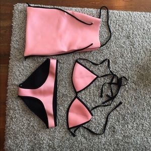 Triangle swimwear bikini. Bright pink and black.