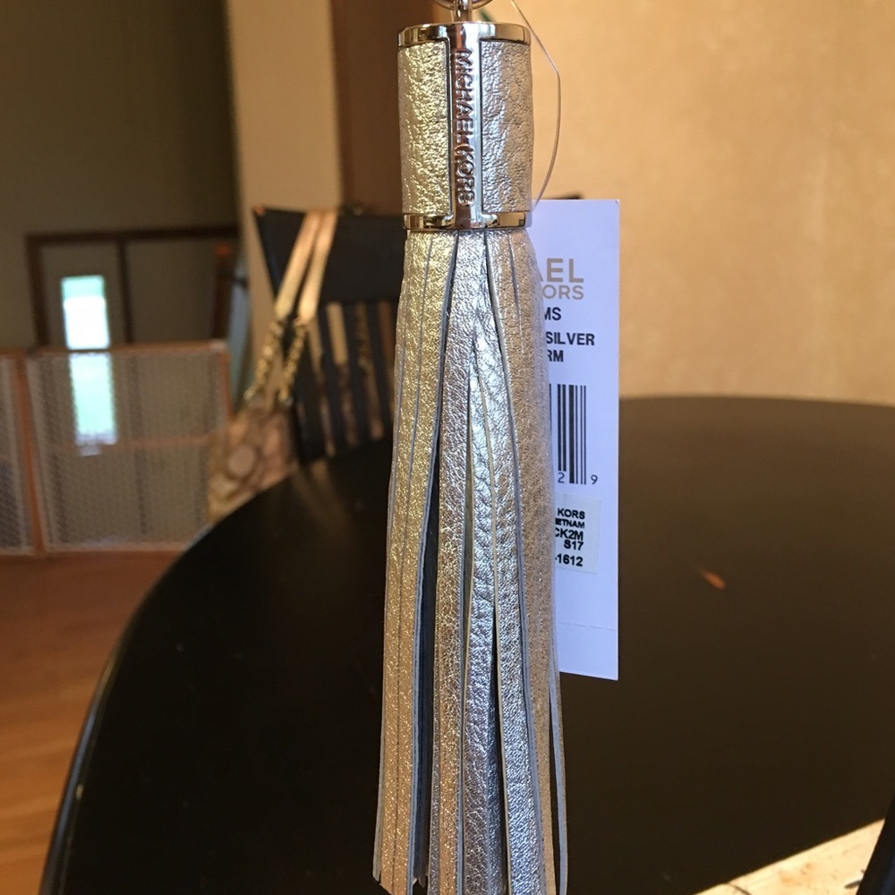 MK SILVER TASSLE FOB/KEY CHARM.