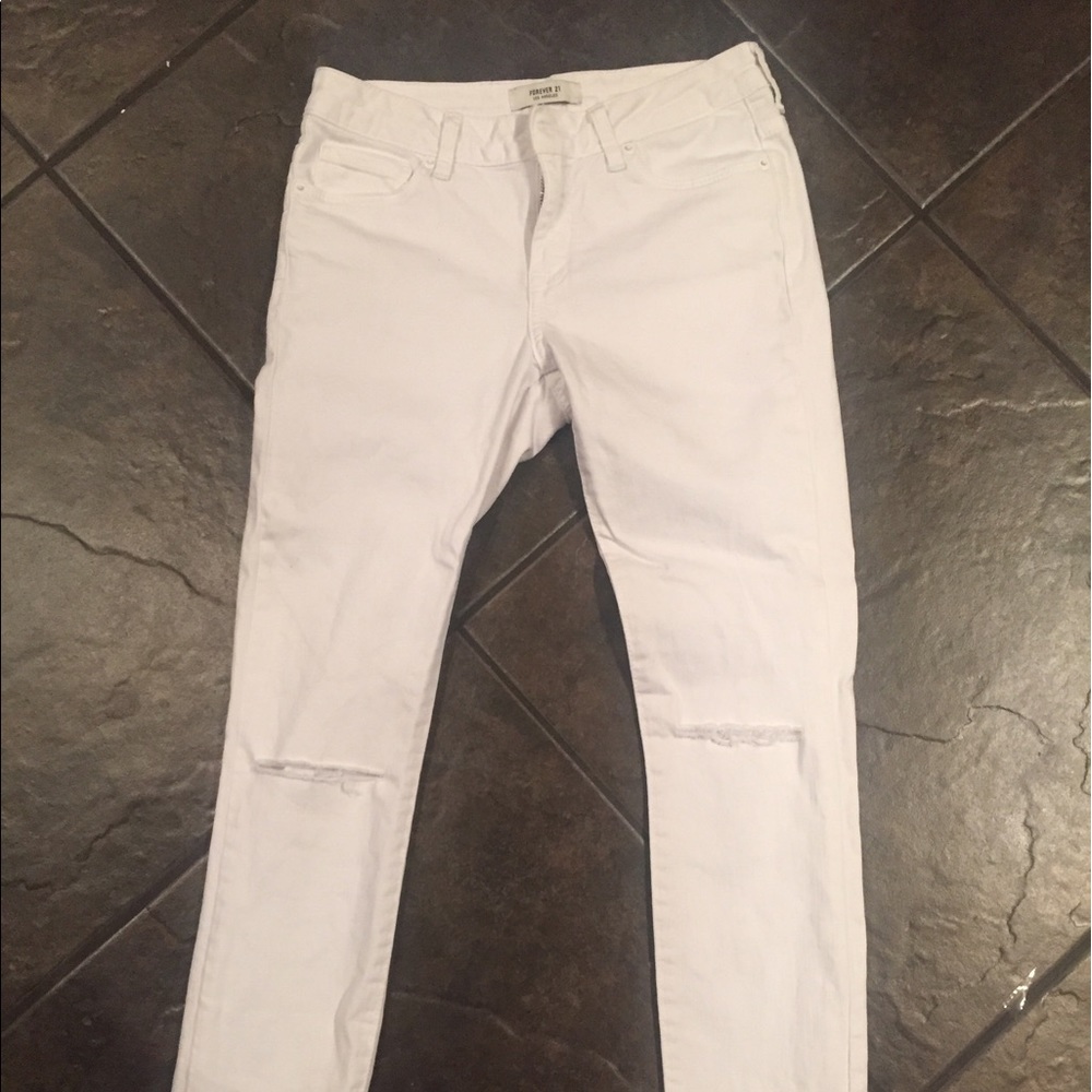 White skinny jeans with cut outs on knees