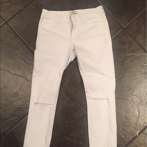 White skinny jeans with cut outs on knees